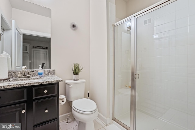 bathroom featuring vanity, toilet, a shower with shower door, and tile patterned flooring