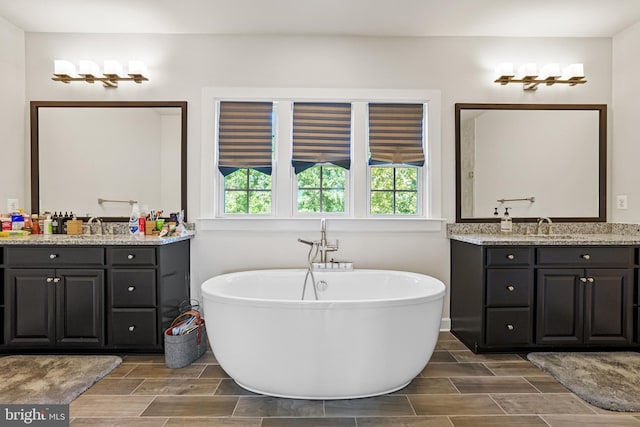 bathroom with vanity and a bath