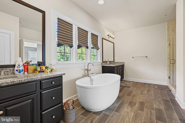 bathroom featuring vanity, hardwood / wood-style flooring, and shower with separate bathtub