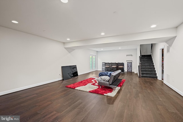 living room with dark hardwood / wood-style flooring