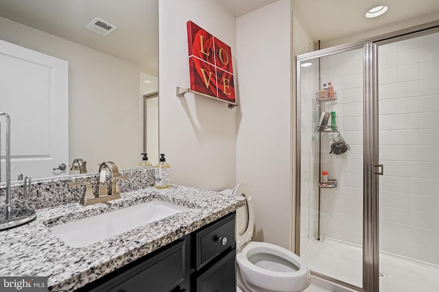 bathroom featuring toilet, an enclosed shower, and vanity