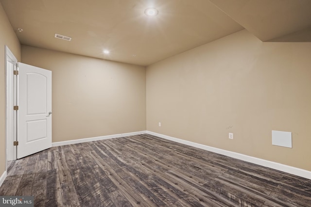 unfurnished room with dark wood-type flooring