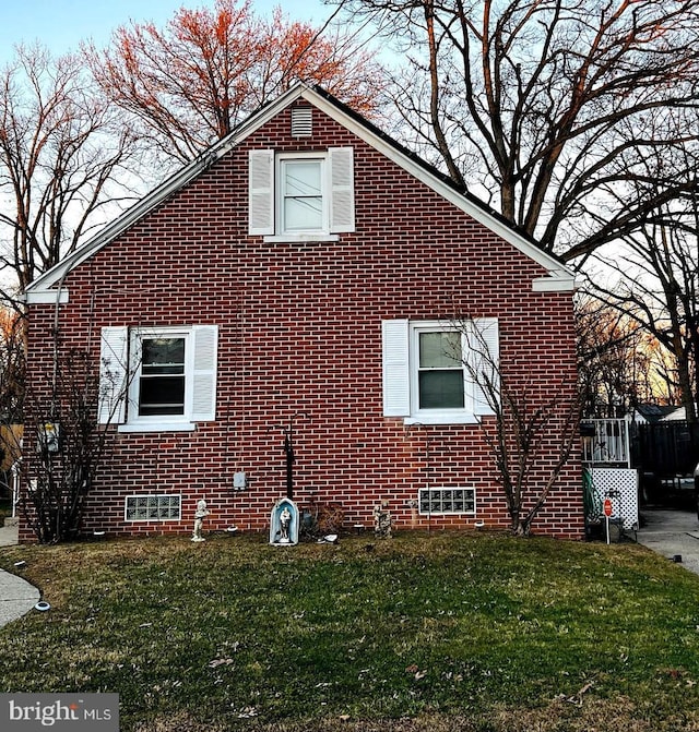 view of side of home featuring a yard