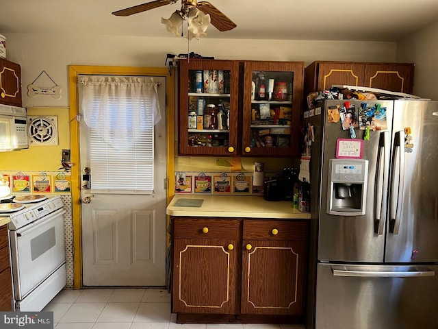 kitchen with white appliances, light tile patterned floors, and ceiling fan