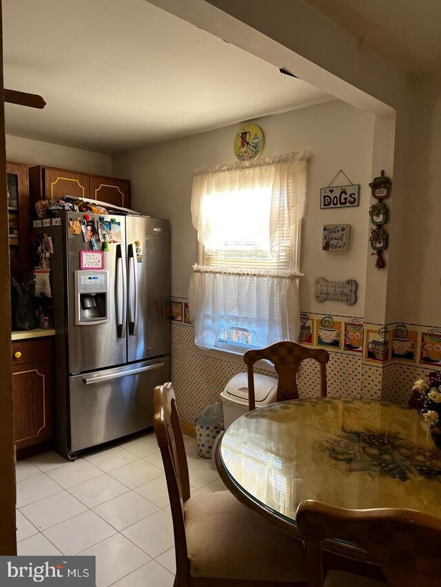 kitchen featuring white appliances, light tile patterned floors, and sink