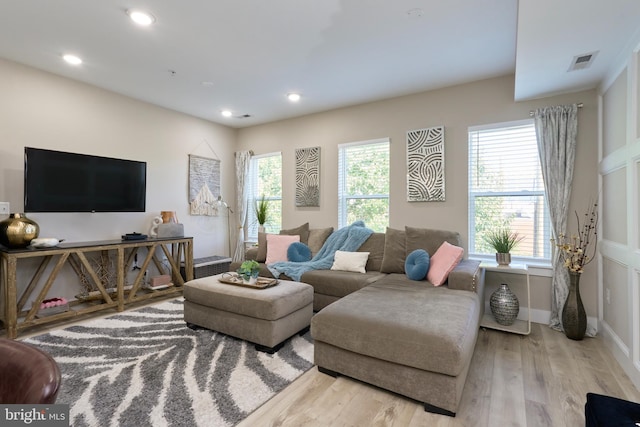 living room featuring a wealth of natural light and light wood-type flooring