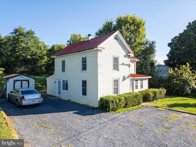 view of property exterior featuring a lawn and a shed