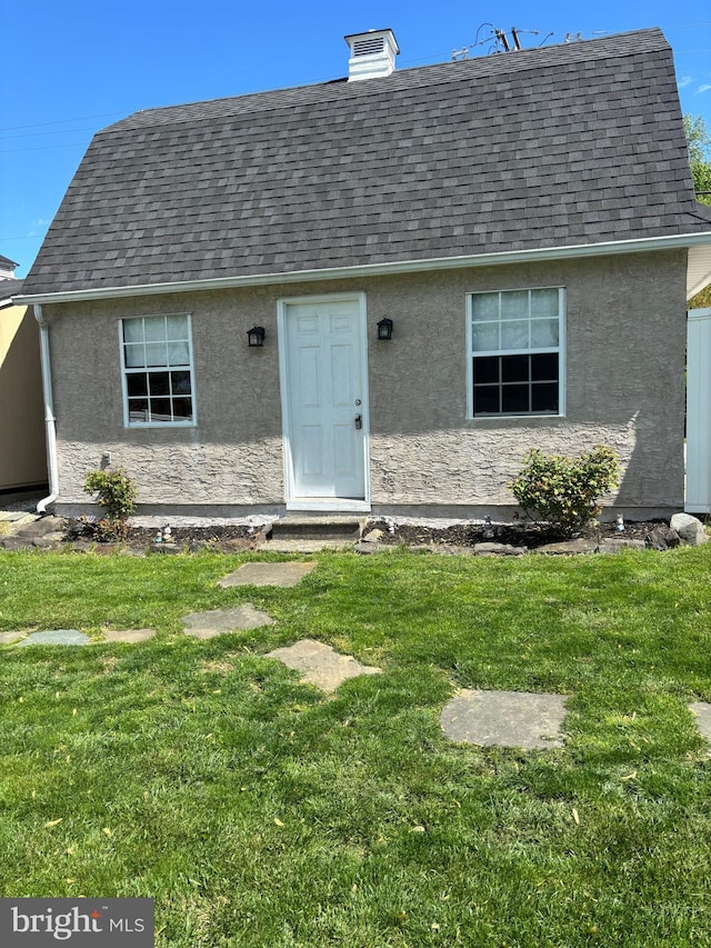 451 Ridge Pike, Lafayette Hill, PA 19444 - property entrance with roof with shingles, stucco siding, and a lawn