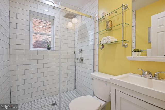 bathroom with a shower with door, vanity, and toilet