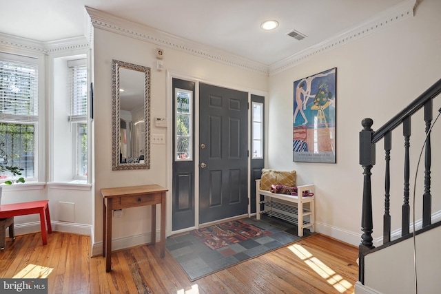 entryway with crown molding and hardwood / wood-style flooring