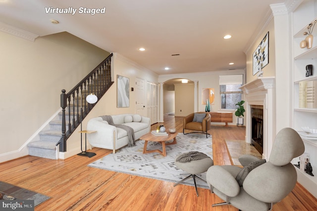 living room with ornamental molding and hardwood / wood-style floors