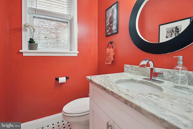 bathroom featuring toilet and vanity