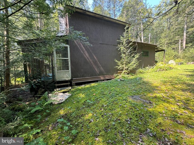 view of home's exterior with a yard