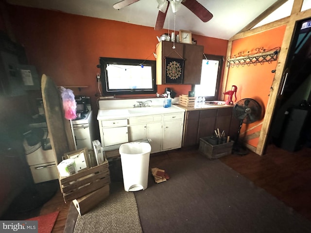 kitchen featuring lofted ceiling, dark hardwood / wood-style flooring, sink, and ceiling fan