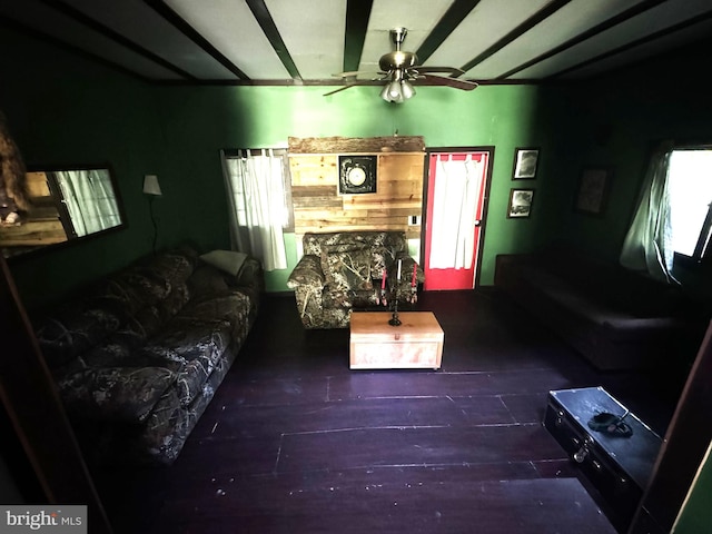 living room with dark wood-type flooring and ceiling fan