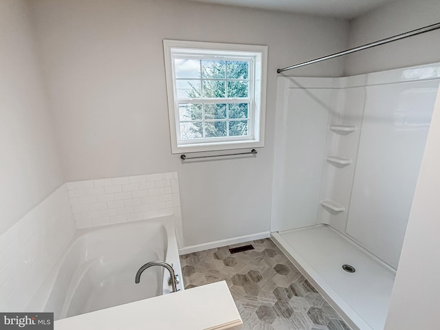 bathroom with a garden tub, visible vents, baseboards, and walk in shower