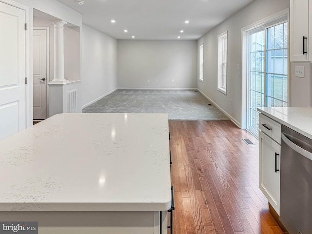 kitchen with light wood-style flooring, white cabinetry, recessed lighting, dishwasher, and ornate columns