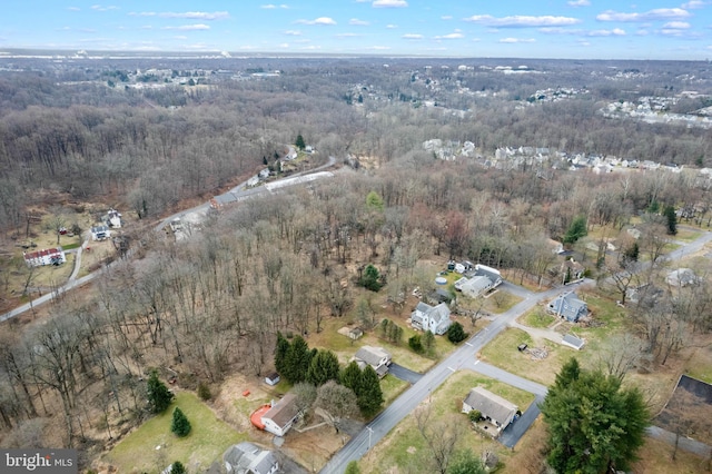 bird's eye view with a wooded view