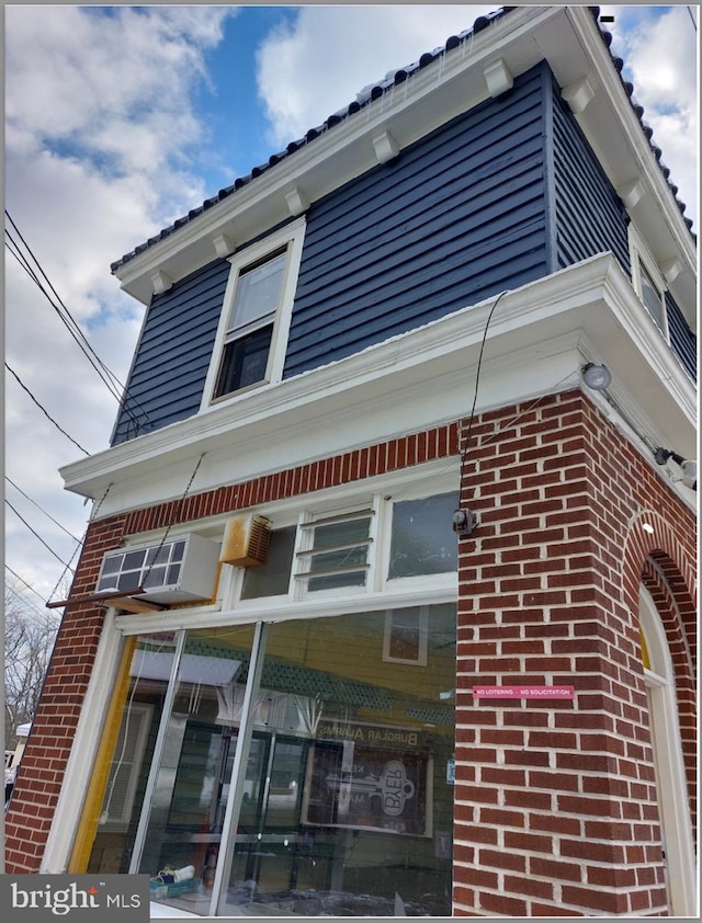 view of side of property with brick siding