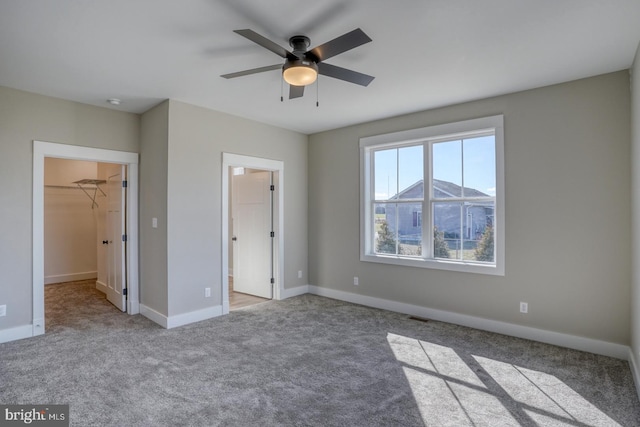 6643 Sharptown Rd, Laurel, DE 19956 - unfurnished bedroom featuring carpet, a spacious closet, baseboards, and ceiling fan