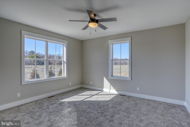 spare room featuring visible vents, baseboards, and carpet floors