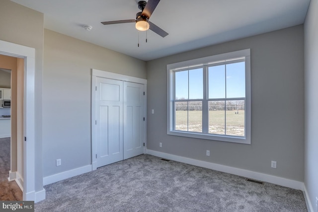 unfurnished bedroom featuring visible vents and baseboards