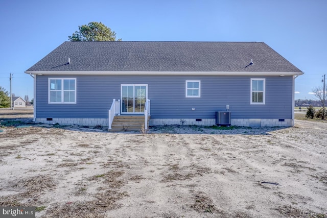 rear view of property featuring crawl space, central air condition unit, and roof with shingles