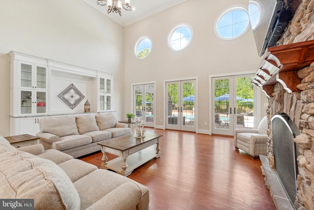 living room with a healthy amount of sunlight, a fireplace, and french doors