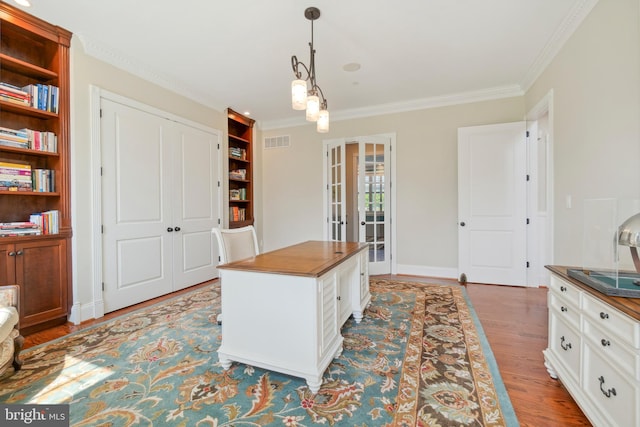 office with ornamental molding, french doors, hardwood / wood-style floors, and a notable chandelier