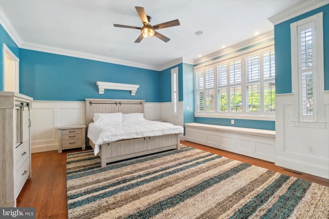 bedroom with crown molding, hardwood / wood-style floors, and ceiling fan