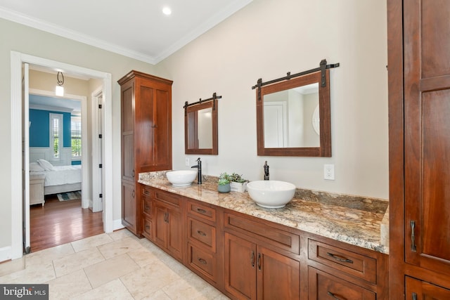 bathroom with ornamental molding and vanity