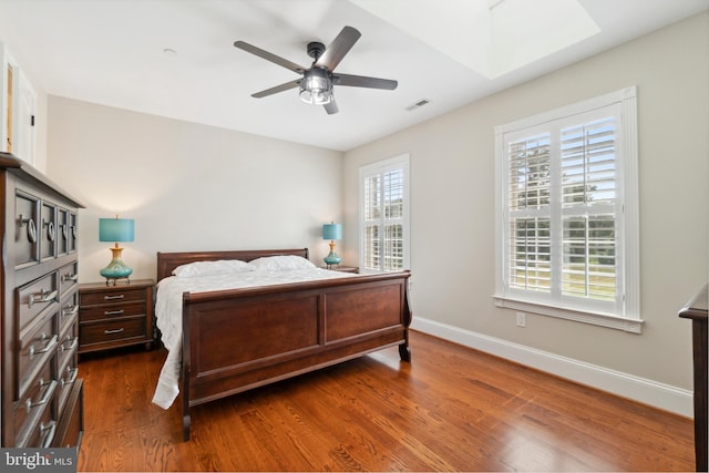 bedroom with ceiling fan and dark hardwood / wood-style floors