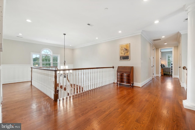 hallway with crown molding and wood-type flooring