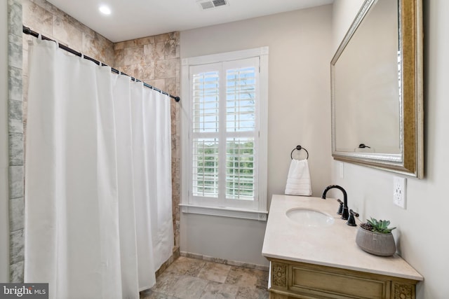 bathroom featuring a shower with curtain, vanity, and a wealth of natural light