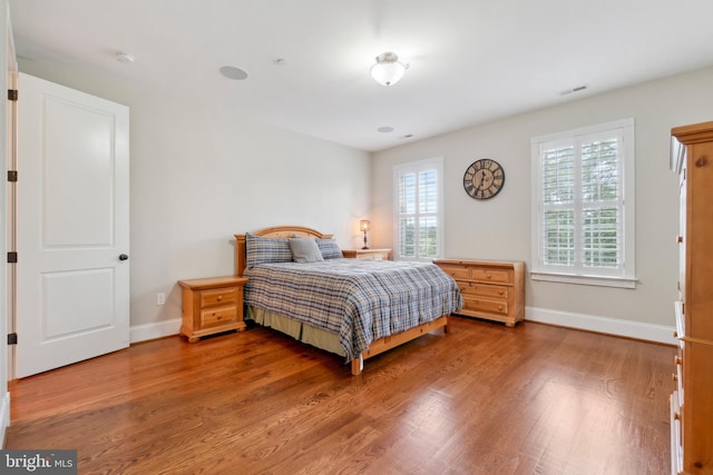 bedroom featuring wood-type flooring and multiple windows