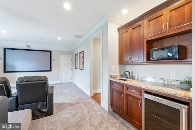 interior space with crown molding, light stone countertops, light carpet, sink, and beverage cooler