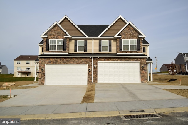 craftsman-style house with concrete driveway and an attached garage