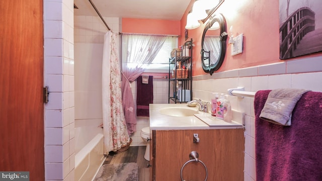 full bathroom with toilet, tile walls, wood-type flooring, tasteful backsplash, and vanity