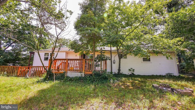 rear view of property featuring a wooden deck