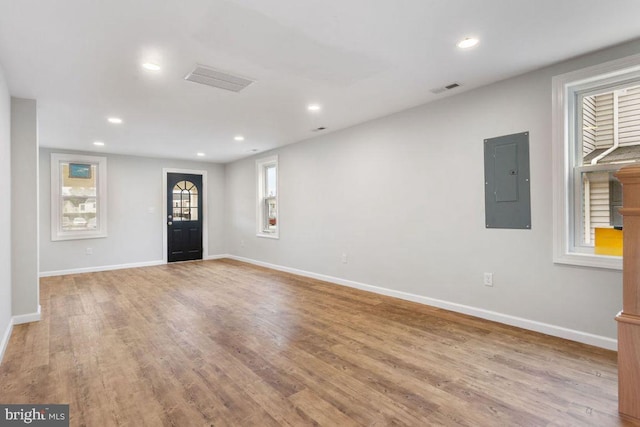 entrance foyer with electric panel and light hardwood / wood-style flooring