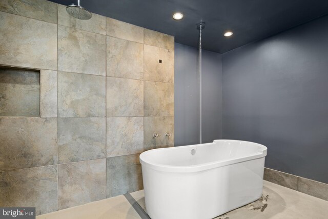 bathroom featuring separate shower and tub