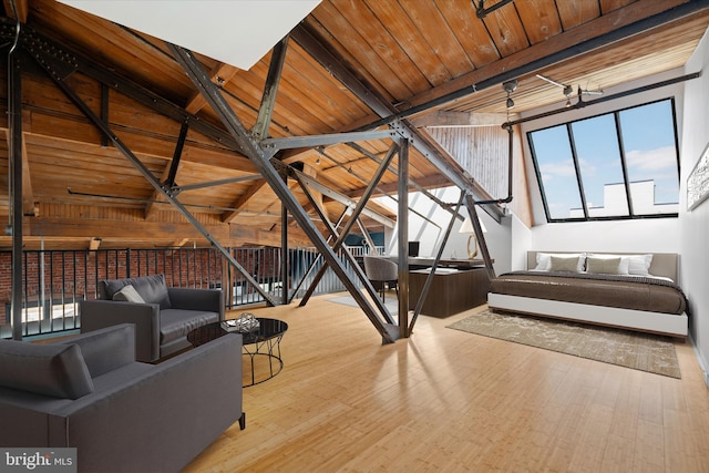 interior space with wooden ceiling, hardwood / wood-style floors, and vaulted ceiling with beams