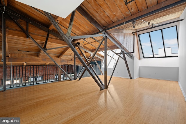 interior space featuring wooden ceiling, lofted ceiling with beams, and light hardwood / wood-style floors