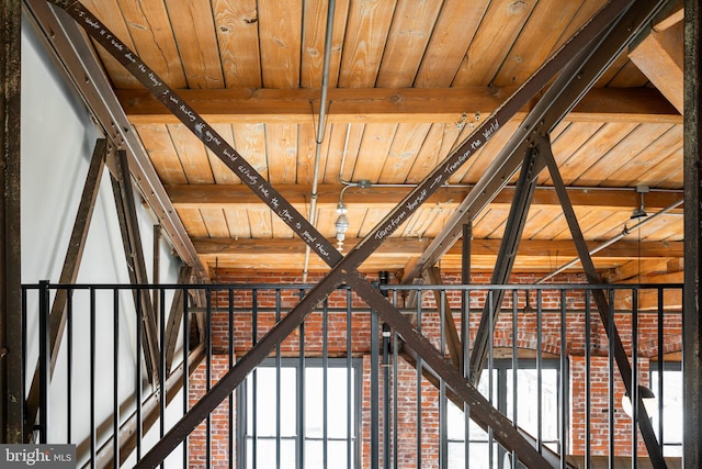 stairs with wood ceiling, plenty of natural light, and beamed ceiling