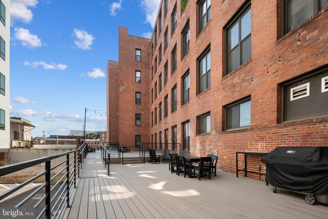 wooden terrace featuring a grill