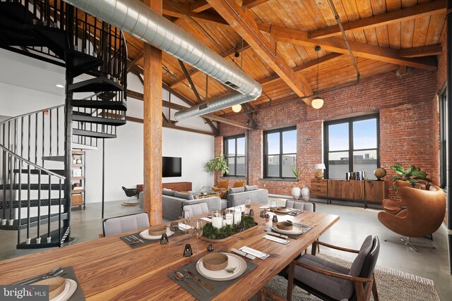 dining space featuring beamed ceiling, concrete floors, a wealth of natural light, wood ceiling, and brick wall