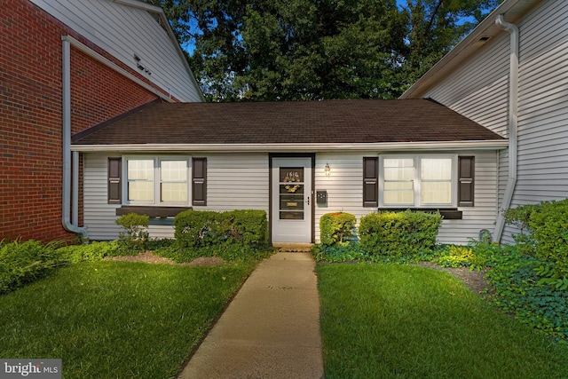 doorway to property featuring a yard