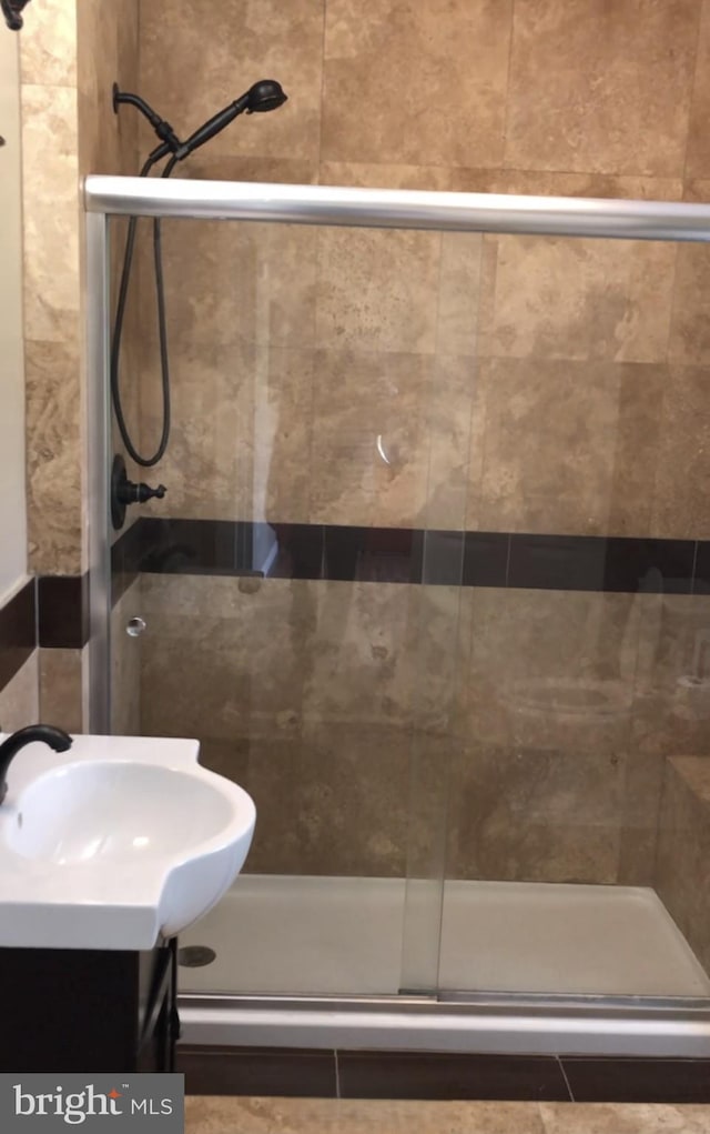 bathroom featuring a stall shower and vanity