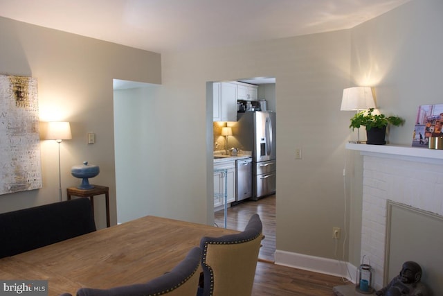 dining room featuring dark wood-type flooring and baseboards