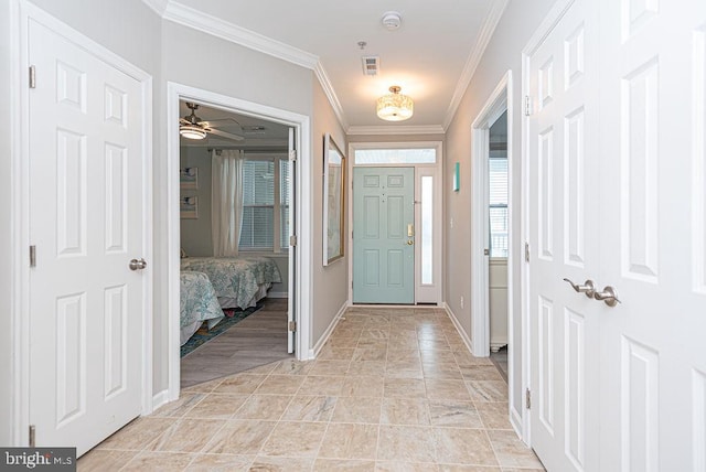 entrance foyer featuring ceiling fan and ornamental molding